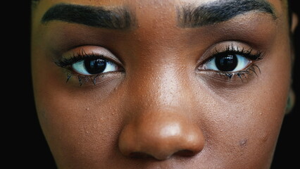 A black teen girl closing eyes in meditation person opening eye macro close-up - obrazy, fototapety, plakaty