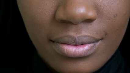 A black girl close-up mouth an african woman face macro