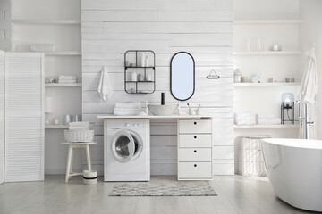 Stylish bathroom interior with modern washing machine