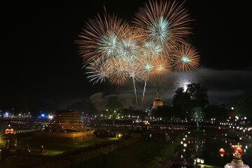 Beautiful red fireworks near the old pagoda during Loy Krathong Festival (Old culture) at Wat Mahathat in Sukhothai Historical Park It is a tradition that has been around since ancient times.
