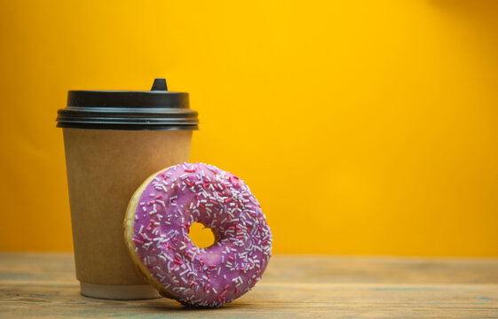 Glazed donuts on wooden background