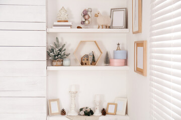 Wall shelves with beautiful Christmas decor indoors. Interior design