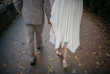 Fototapeta premium View of a couple walking on the street. Couple holding hands.