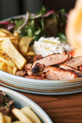 Greek Gyros with chicken or veal, with tzatziki on a dark background