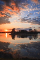 Beautiful morning spring landscape. Sunrise over the lake with a beautiful sky.