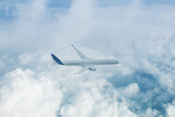 Fototapeta na wymiar Passenger plane flies high above the clouds aerial view.