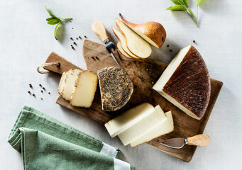 several types of Italian cheese on a cutting board. appetizer or aperitif