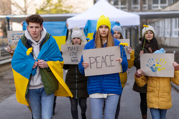 Protest against Russian invasion of Ukraine. People holding anti war sings and banners in street.