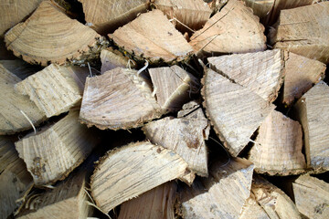 Neatly stacked firewood for kindling front view.