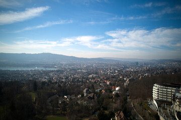 Aerial view over City of Zürich with local mountain Uetliberg and Lake Zürich in the background on a sunny spring day. Photo taken March 1st, 2022, Zurich, Switzerland.