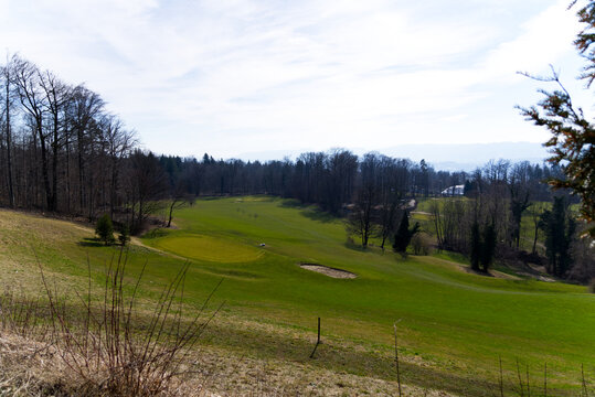 Beautiful small golf course with nine holes and bunker at City of Zürich on a sunny spring day. Photo taken March 1st, 2022, Zurich, Switzerland.