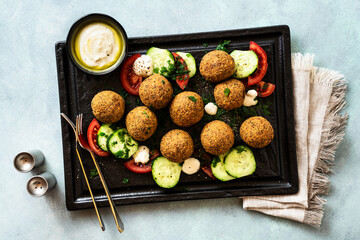 fried in oil falafel with cucumber-tomato salad and yoghurt with olive oil
