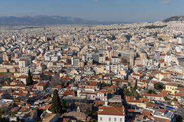 Fototapeta na wymiar Athens Greek capital seen from above. Bird's eye view from Acropolis over the city with white houses, towers.