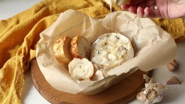 Cooking camembert with croutons in the oven. Step 5 Bake. Baked camembert with garlic sauce and spices. Cheese stretches, drips. Homemade brie in the oven.