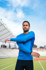 Black Athlete Stretching in Sports Track