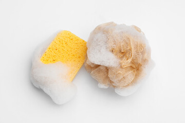 Soft soapy sponges with foam isolated on white background
