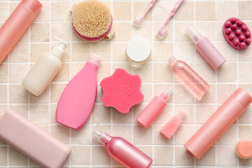 Composition with different cosmetic products and bath accessories on color tile