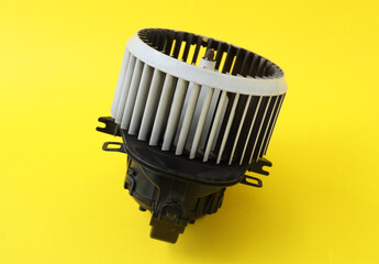 Car heater fan on yellow background