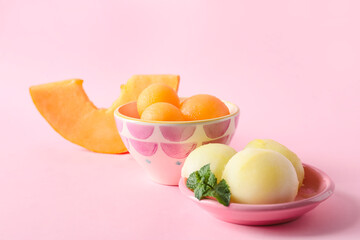 Bowls with tasty melon sorbet on pink background