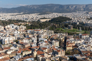 Fototapeta na wymiar Athens Greek capital seen from above. Bird's eye view from Acropolis over the city with white houses, towers.