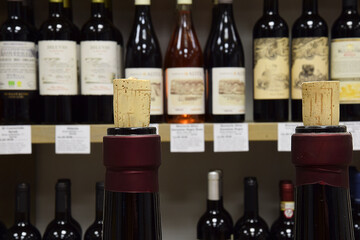 Wine bottles on wooden shelf in wine store