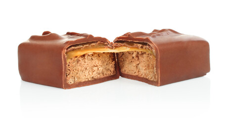 Broken chocolate bar with stretching caramel isolated on white background