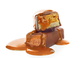 Pouring caramel on broken chocolate bars on white background
