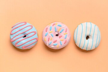 Different sweet donuts on color background