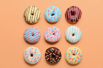 Different sweet donuts on color background