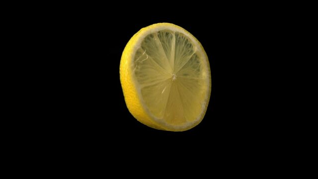 Lemon slice rotating in front of blank background