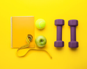 Stylish sport equipment on yellow background