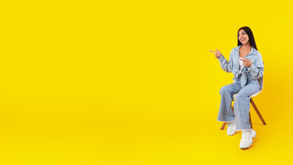 Excited woman pointing aside at free copy space