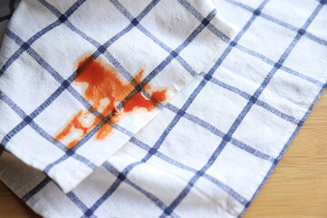 Dirty sauce stain on white shirt from eating in home of daily life activity. dirty stains for...