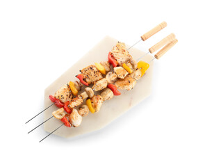 Board of grilled chicken skewers with vegetables isolated on white background