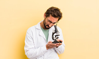 young man. scientist with microscope concept