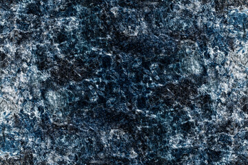 Abstract rough textured dark blue color old stone wall surface for background