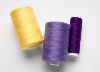 Different thread spools on white background