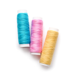 Different thread spools on white background