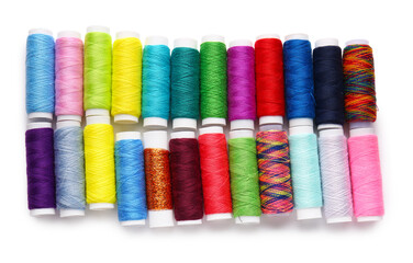 Different thread spools on white background