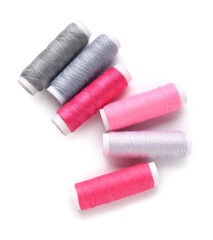 Different thread spools on white background