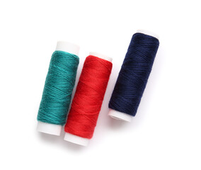 Different thread spools on white background