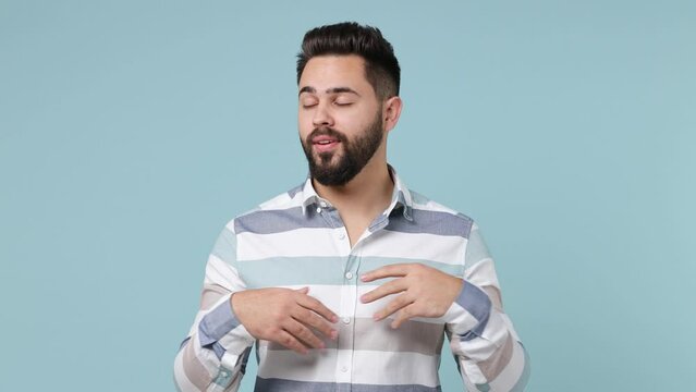 Boring dull tedious young bearded brunet man 20s years old wears striped shirt applause clapping hands isolated on plain pastel light blue background studio portrait. People emotions lifestyle concept