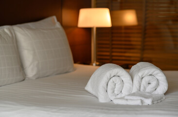 Clean white towel set on bed in hotel bedroom, relax, holiday, vacation concept.