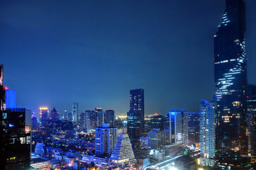 Fototapeta na wymiar Nighttime in Bangkok city at night in Thailand. Aerial view of cityscape. Modern buildings, urban architecture.
