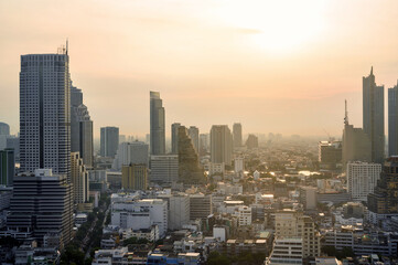 Obraz premium Cityscape of modern buildings and urban architecture. Aerial view of Bangkok city at twilight sunset in Thailand.