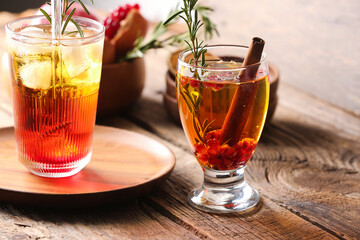 Glasses of tasty pomegranate cocktail on wooden background