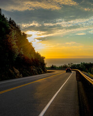 Sunset at Cabot trail in Cape Breton, Canada. Winding roads, by the Atlantic Ocean coastline.