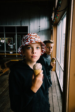 Two Teen Boys Eating Chocolate Ice cream cones in Astoria