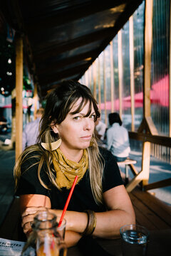 Woman Patiently Waits for Lunch at an Outdoor Brewery