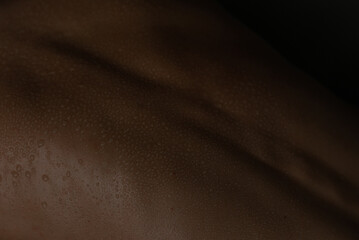 Close up of water on spine and back of woman skin